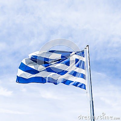 Greek flag and cloudy sky in summer day, politics of Europe Stock Photo