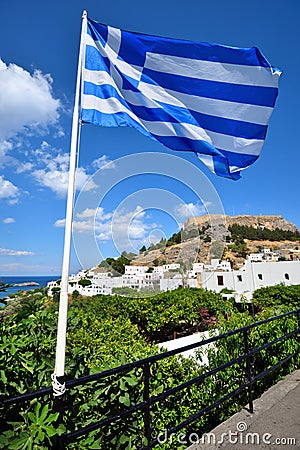 Greek flag flying in the city of Lindos on the island of Rhodes Stock Photo