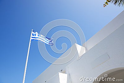 The Greek flag and hotel building, Santorini island Stock Photo