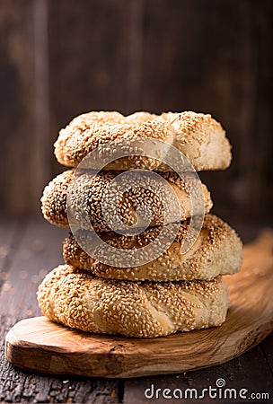 Greek koulouri or Turkish bagels called Simit in stack. Traditional street food, crispy sesame bread ring bagels Stock Photo