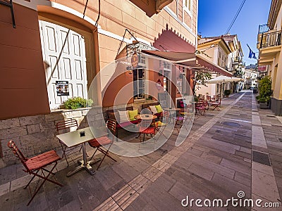 Greek restaurant in shaded alley Editorial Stock Photo