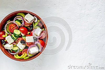 Greek salad on a concrete background. Tomatoes, peppers, olives, cheese, onions. Healthy eating. Diet. Vegetarian food Stock Photo