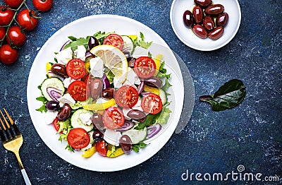Greek salad with feta cheese, kalamata olives, red tomato, yellow paprika, cucumber and red onion, healthy mediterranean diet food Stock Photo