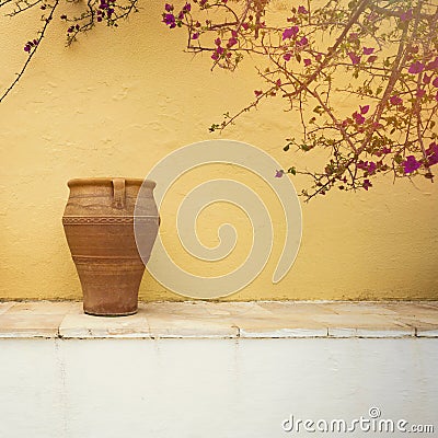 Greek village house detail. Vintage vase over wall background Stock Photo