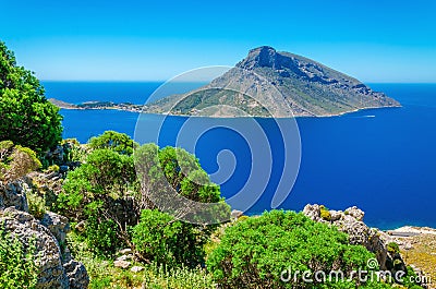 Greek volcano Island with green bushes, Greece Stock Photo