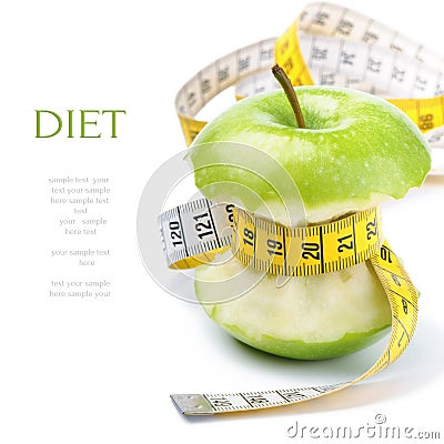 Green apple core and measuring tape Stock Photo