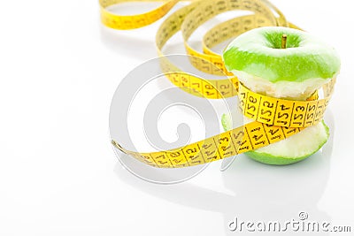Green apple core and measuring tape Stock Photo