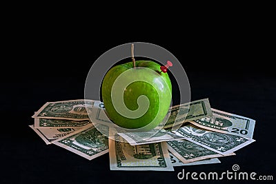 Green apple on dollars cash Stock Photo