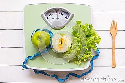 Green apple, fresh vegetable with weight scale and measuring tape for the healthy diet slimming Stock Photo