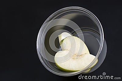 Green apple slice on plastic container. Dietary foods and weight loss concept Stock Photo