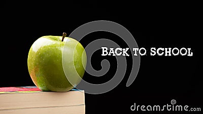 Green Apple on stacks Books on Desk for Back to School Stock Photo