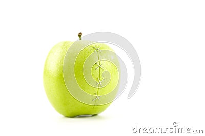 Green apple with stapled crack Stock Photo