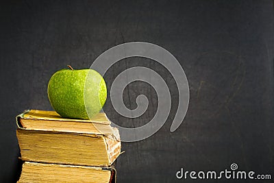 Green apple on textbook Stock Photo