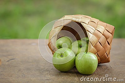 Green apples in a birchbark basket Stock Photo