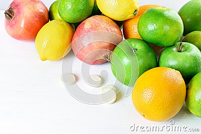 Green apples, mandarins, oranges, limons, garnets and multivitamins isolated on the white background. Healthy food boost immunity Stock Photo