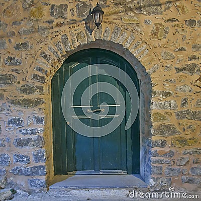 Green arched door, night view, Chios island Stock Photo