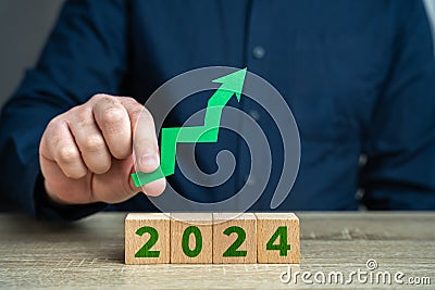 2024 and green arrow up. Forecast for an increase next year. Stock Photo