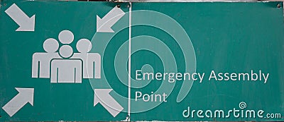 Green assembly point sign. Sign with a symbol that shows where people should gather in the event of an emergency. Stock Photo