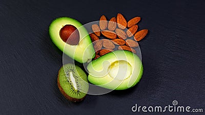 Green assortment vegetables and fruits, avocados, kiwi and almonds, nuts on a shale board, the concept of healthy eating, copy spa Stock Photo