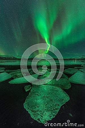 A green aurora over the Jokulsarlon lagoon, Iceland Stock Photo