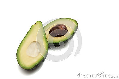 Green avocado cut in half lying on a white background Stock Photo