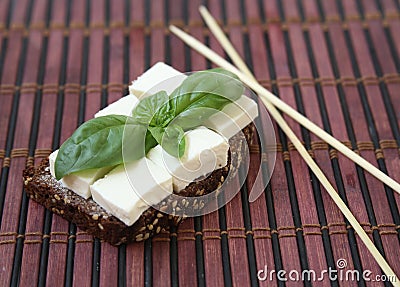 Green basilicas and chees on toast. Stock Photo