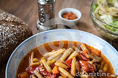 Vegetarian lunch. Green bean soup with tomato sauce and vegetables Stock Photo