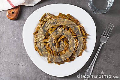 Green beans with olive oil on a white porcelain plate. Healthy eating concept Stock Photo