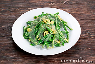 Green beans roasted in garlic and flaked almond Stock Photo