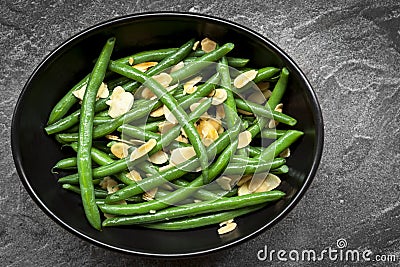 Green Beans with Toasted Almonds in Black Bowl Stock Photo