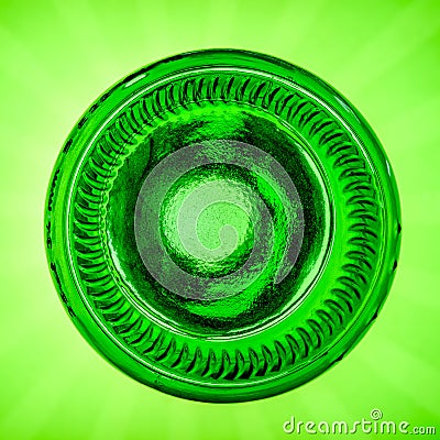 Upside down green beer bottle on a green background Stock Photo