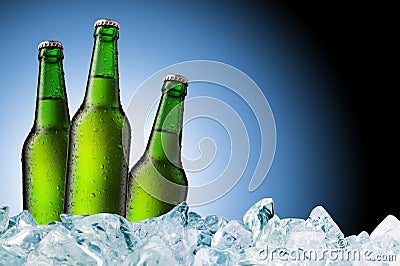 Green beer bottles on ice Stock Photo