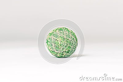 Green and beige knitted ball, pet toy, lying down on emtpy white background in the center of composition. Stock Photo