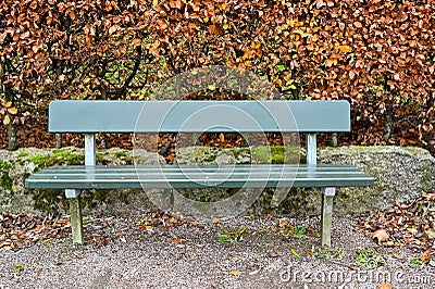 green bench infront of a autumn hedge Stock Photo