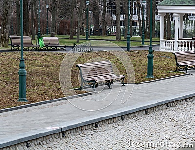 Green Benches in a city park Stock Photo