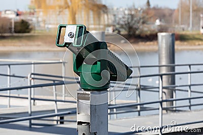 Green binoculars at a ski pier without people, by day Stock Photo