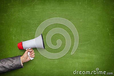 Green blank blackboard with hand holding megaphone Stock Photo