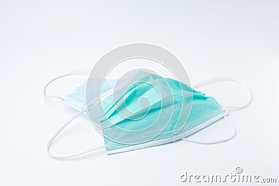 Green and blue disposable surgical face mask dirty top view. Mask protective coronavirus isolated on white background. Stock Photo