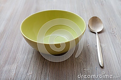 Green bowl and spoon on gray brown table Stock Photo