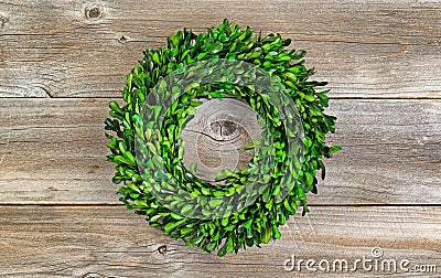 Green Boxwood Leaf Wreath on Rustic Wood Stock Photo