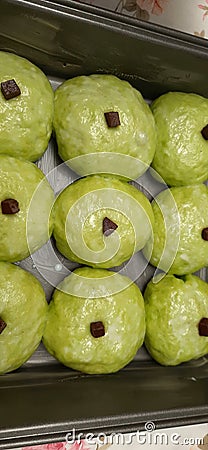 Green bread is ready to be burned. Chocolate flavored bread with delicious topping. Stock Photo