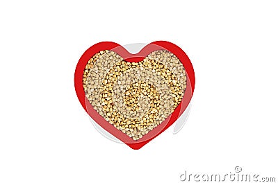 Green buckwheat groats in heart shape red frame isolated on white. Stock Photo