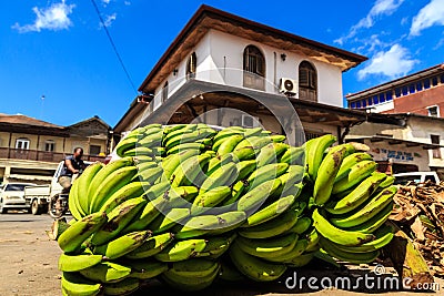 Green bunch of bananas lying in a street Stock Photo
