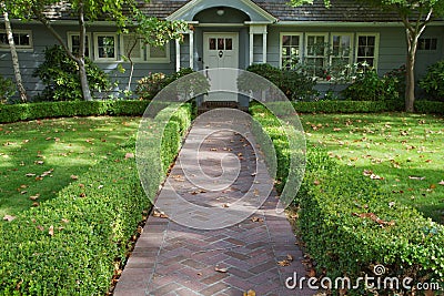 Green bush lined home entrance Stock Photo