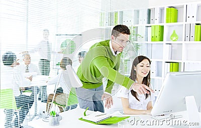 Green Business Partnership working on computer Stock Photo