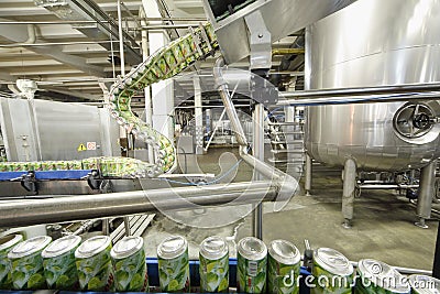 Green cans go on conveyor in Ochakovo factory Editorial Stock Photo