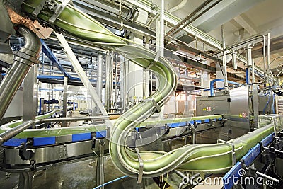 Green cans move fast on conveyor in Ochakovo Editorial Stock Photo