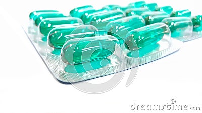 Green capsule blisters ,Cyan Pills in strip packs. Soft oil cap Stock Photo