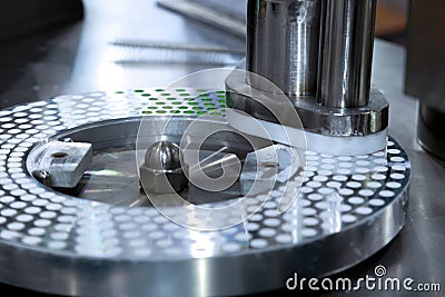 Green capsule medicine pill in the production line of medicine filling machine at pharmaceutical manufacturing factory. medical Stock Photo
