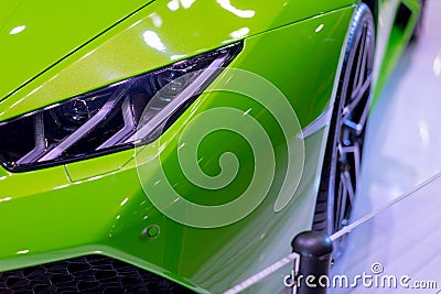 Green car in the exhibition room at the light sensitivity. Stock Photo